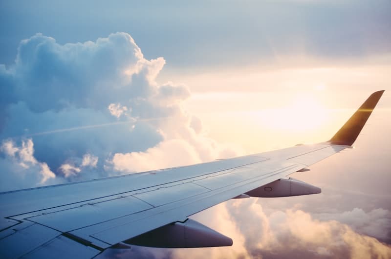 View of the wing from an airplane window above the clouds