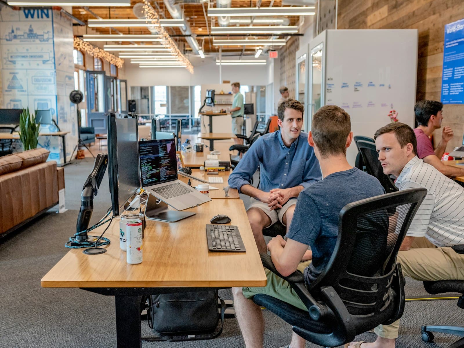 Colleagues collaborating around a desk in a modern office