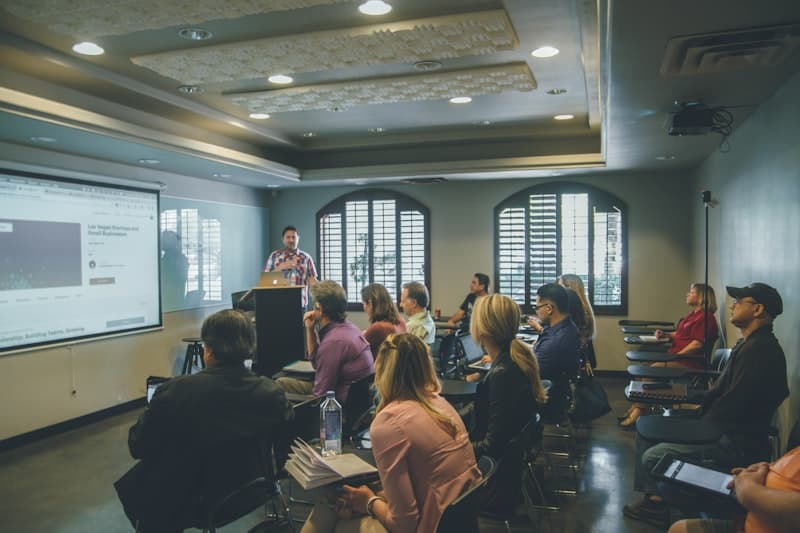 Speaker presenting to an audience in a seminar room
