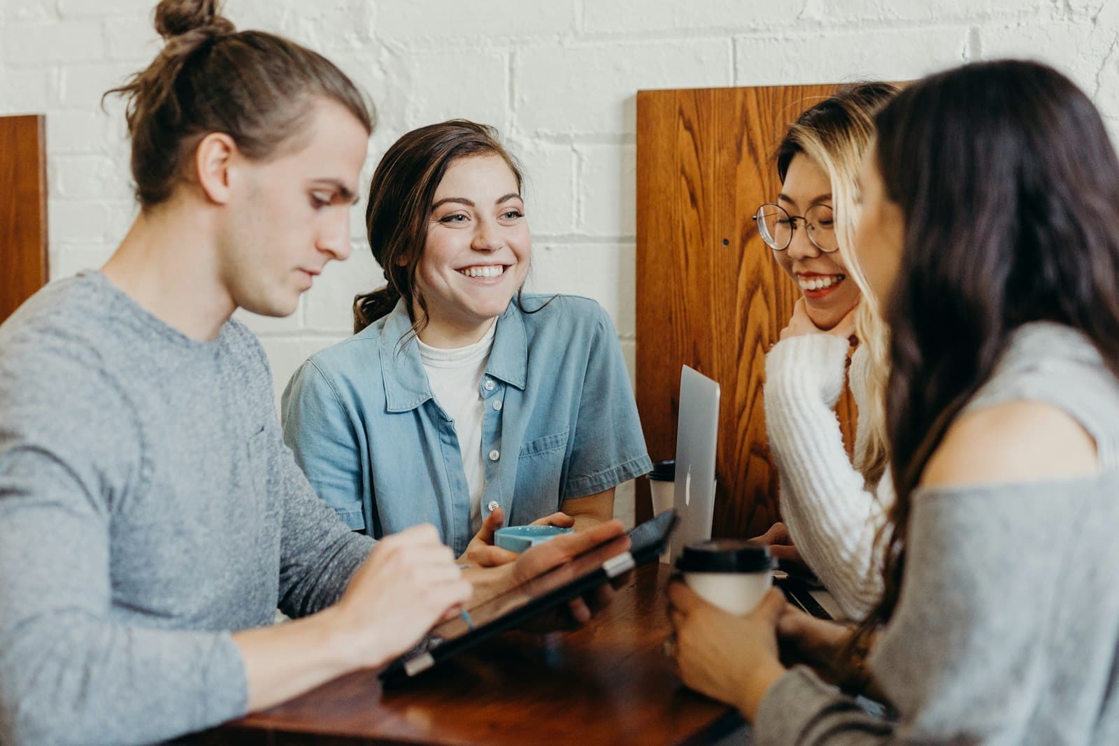 A group smiling and learning together around a table